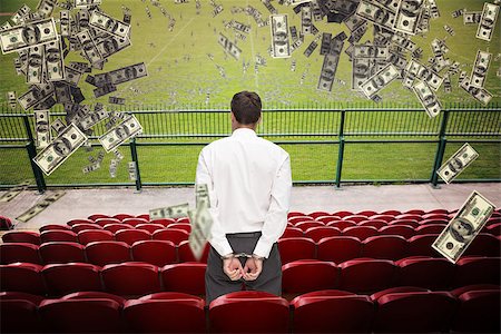 soccer arena - Rear view of young businessman wearing handcuffs against red bleachers looking down on football pitch Stock Photo - Budget Royalty-Free & Subscription, Code: 400-08200457