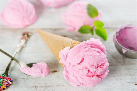 simsearch:400-05718903,k - Pink ice cream in waffle cone with utensil on rustic wooden background. Stock Photo - Budget Royalty-Free & Subscription, Code: 400-08223844
