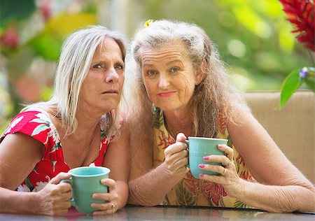 Pair of Caucasian doubting friends with coffee mugs Stock Photo - Budget Royalty-Free & Subscription, Code: 400-08254683