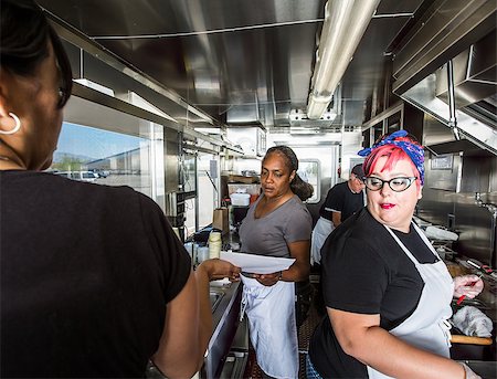 Female chef with pink hair works alongside crew on food truck Stock Photo - Budget Royalty-Free & Subscription, Code: 400-08254982