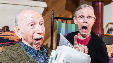 Angry older couple reading newspaper in living-room Stock Photo - Budget Royalty-Free & Subscription, Code: 400-08254998