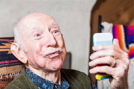 funny old people faces - Older man looking at camera while taking silly face selfie Stock Photo - Budget Royalty-Free & Subscription, Code: 400-08255186