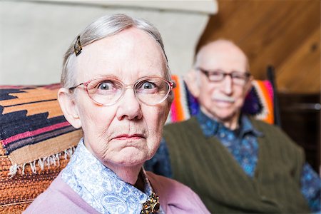 Old couple seating in livingroom woman scowling Stock Photo - Budget Royalty-Free & Subscription, Code: 400-08255852