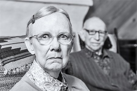 Elderly scowling couple seated in indoors woman Stock Photo - Budget Royalty-Free & Subscription, Code: 400-08255853