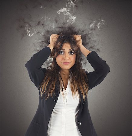 simsearch:400-04902701,k - Businesswoman stressed with her head in smoke Stock Photo - Budget Royalty-Free & Subscription, Code: 400-08256202