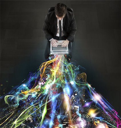 Man sitting with laptop and light beams Stock Photo - Budget Royalty-Free & Subscription, Code: 400-08256842