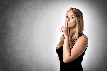 simsearch:400-04175955,k - Blond woman with a finger to his lips to indicate to be quiet Stock Photo - Budget Royalty-Free & Subscription, Code: 400-08251465