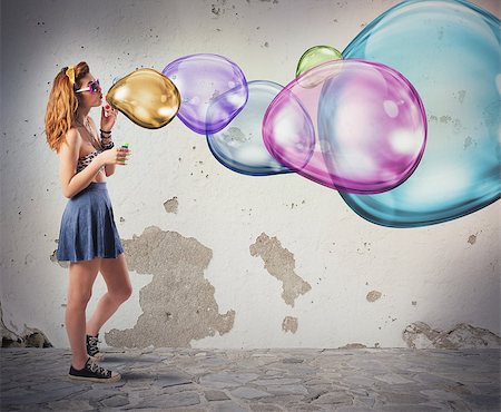 Girl has fun making colorful soap bubbles Foto de stock - Super Valor sin royalties y Suscripción, Código: 400-08252678