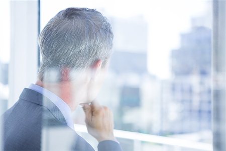 simsearch:400-04283915,k - Thinking businessman in the office looking through the window Stock Photo - Budget Royalty-Free & Subscription, Code: 400-08264469