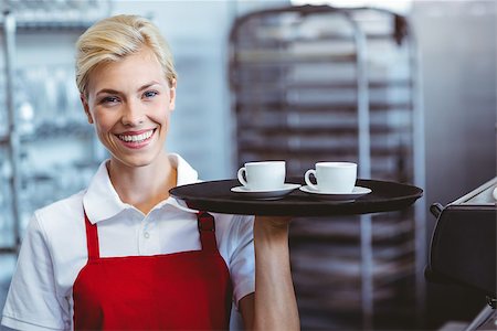 simsearch:400-07750853,k - Pretty barista holding two cups of coffee in the cafe Stock Photo - Budget Royalty-Free & Subscription, Code: 400-08265818