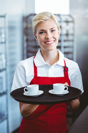 simsearch:400-07750853,k - Pretty barista holding two cups of coffee in the cafe Stock Photo - Budget Royalty-Free & Subscription, Code: 400-08265819