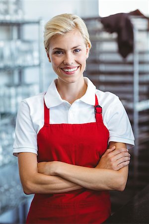 simsearch:400-07750853,k - Pretty barista smiling at the camera with arms crossed Stock Photo - Budget Royalty-Free & Subscription, Code: 400-08265813