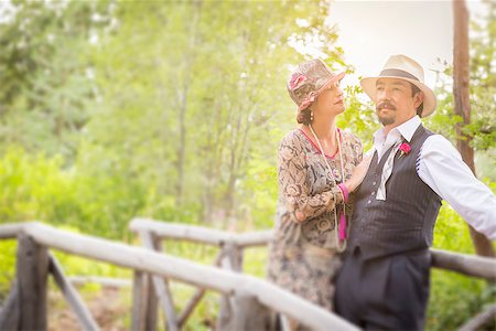 Attractive 1920s Dressed Romantic Couple on Wooden Bridge. Stock Photo - Budget Royalty-Free & Subscription, Code: 400-08262778