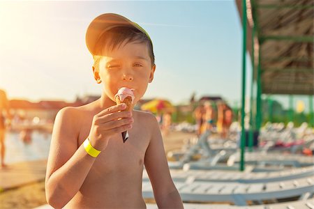 Baby boy with ice-cream at the beach Stock Photo - Budget Royalty-Free & Subscription, Code: 400-08284559