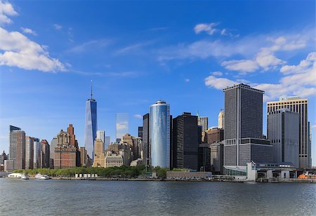 It's a view of Manhattan, New York City during the sunny day with a blue sky and riverside. There are many important building and places stated in that area which is a landmark of America about business and finance. Stock Photo - Budget Royalty-Free & Subscription, Code: 400-08284775