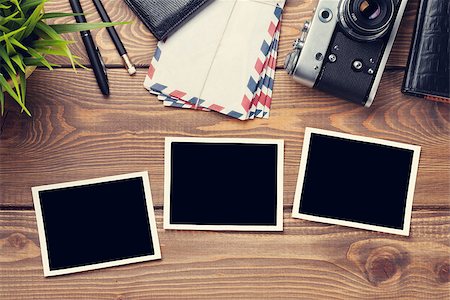 Blank photo frames, camera and supplies on wooden table. Top view. Toned Stock Photo - Budget Royalty-Free & Subscription, Code: 400-08287339