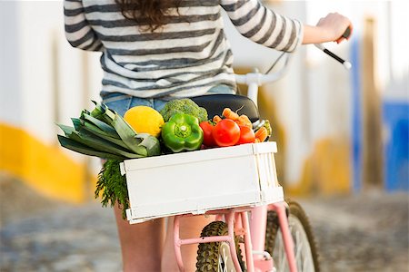 riding bike female basket - Beautiful female tourist living like a local, with her bicycle after buying some fresh vegetables Stock Photo - Budget Royalty-Free & Subscription, Code: 400-08288020