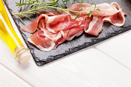 simsearch:400-06207145,k - Prosciutto with rosemary and olive oil on wooden table Stock Photo - Budget Royalty-Free & Subscription, Code: 400-08288468