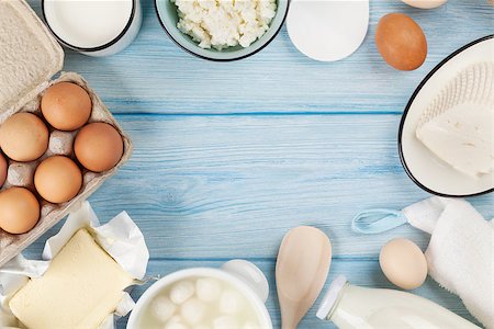 Dairy products on wooden table. Sour cream, milk, cheese, egg, yogurt and butter. Top view with copy space Stock Photo - Budget Royalty-Free & Subscription, Code: 400-08288462