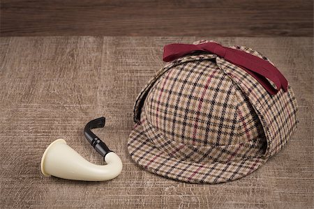 Deerstalker or Sherlock Hat and Tobacco pipe on Old Wooden table. Stock Photo - Budget Royalty-Free & Subscription, Code: 400-08289314