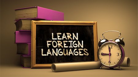 simsearch:400-04331637,k - Learn Foreign Languages Handwritten on Chalkboard. Time Concept. Composition with Chalkboard and Stack of Books, Alarm Clock and Scrolls on Blurred Background. Toned Image. Stock Photo - Budget Royalty-Free & Subscription, Code: 400-08294249