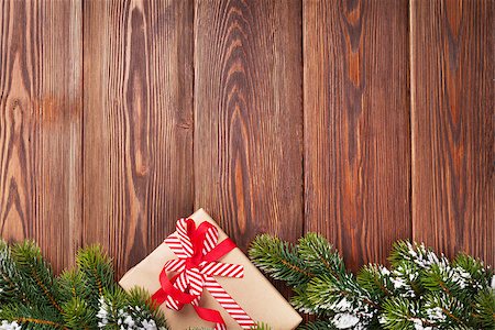 Christmas wooden background with snow fir tree and gift box. View with copy space Stock Photo - Budget Royalty-Free & Subscription, Code: 400-08295005