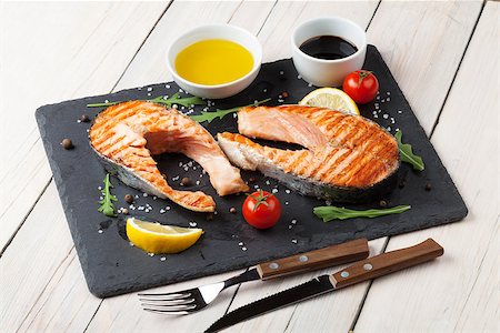 Grilled salmon, salad and condiments on wooden table Stock Photo - Budget Royalty-Free & Subscription, Code: 400-08298804