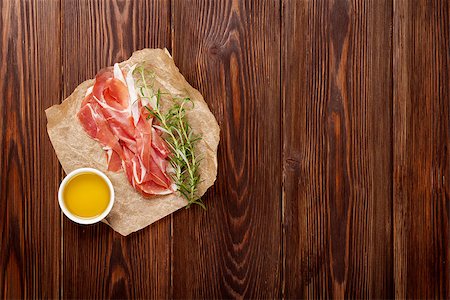 simsearch:400-06207145,k - Prosciutto with rosemary and olive oil on wooden table. Top view with copy space Stock Photo - Budget Royalty-Free & Subscription, Code: 400-08298824