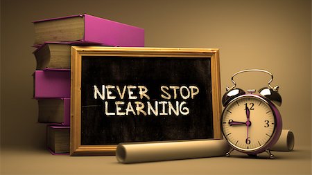 Never Stop Learning Handwritten by white Chalk on a Blackboard. Composition with Small Chalkboard and Stack of Books, Alarm Clock and Rolls of Paper on Blurred Background. Toned Image. Stock Photo - Budget Royalty-Free & Subscription, Code: 400-08298984