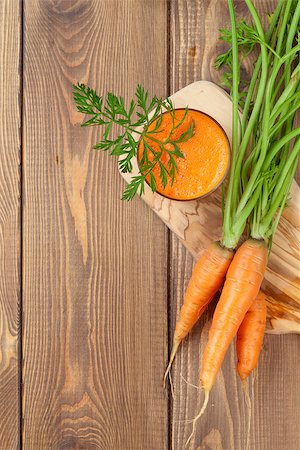 simsearch:400-06864386,k - Fresh carrot juice smoothie and roots on wooden table. Top view with copy space Stock Photo - Budget Royalty-Free & Subscription, Code: 400-08291294