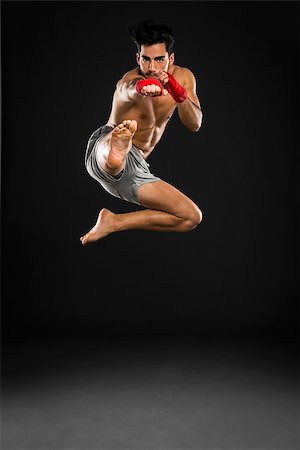 simsearch:400-05908874,k - Portrait of a young male Body Combat atlhlete, jumping and kicking Stock Photo - Budget Royalty-Free & Subscription, Code: 400-08292209