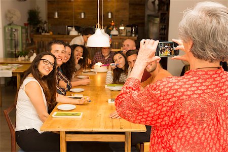 elder woman table - Granny taking a picture of all family celebrating the birthday grandfather Stock Photo - Budget Royalty-Free & Subscription, Code: 400-08292252
