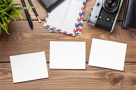 Blank photo frames, camera and supplies on wooden table. Top view. Stock Photo - Budget Royalty-Free & Subscription, Code: 400-08300725