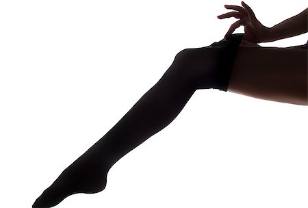 stocking feet - lady puts on stockings in silhouette Stock Photo - Budget Royalty-Free & Subscription, Code: 400-08314947