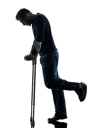 full body cast - one man injured man walking sad with crutches in silhouette studio on white background Stock Photo - Budget Royalty-Free & Subscription, Code: 400-08316785