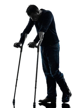 full body cast - one man injured man walking sad with crutches in silhouette studio on white background Stock Photo - Budget Royalty-Free & Subscription, Code: 400-08316780