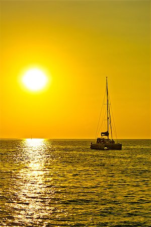 simsearch:400-07748817,k - Catamaran sailboat at golden sunset on open sea vertical view Stock Photo - Budget Royalty-Free & Subscription, Code: 400-08317525