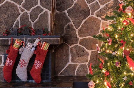 Stockings hanging on a fireplace next to a christmas tree on christmas morning Stock Photo - Budget Royalty-Free & Subscription, Code: 400-08317758