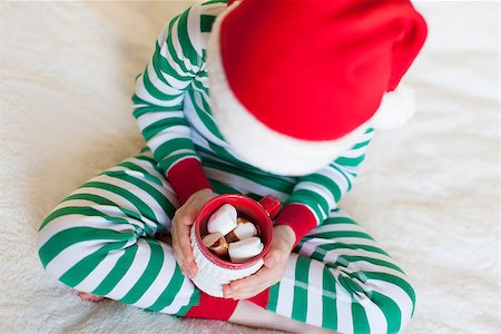 close-up of little boy in cozy pajamas holding cup with hot cocoa enjoying christmas time at home, shallow DOF Stock Photo - Budget Royalty-Free & Subscription, Code: 400-08319516