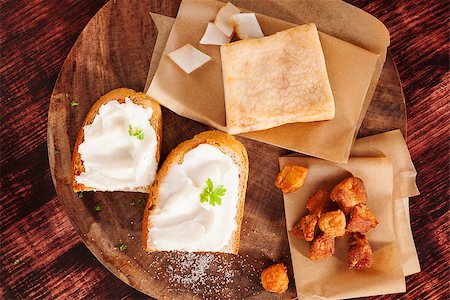simsearch:400-04885499,k - Pork scratchings, bacon and bread with lard spread on wooden kitchen board on wooden background, top view. Traditional british eating. Stock Photo - Budget Royalty-Free & Subscription, Code: 400-08319593