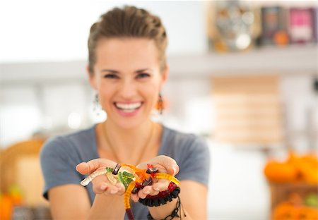 Closeup on colorful halloween gummy worm candies in woman hands. Kids will be stunned! Traditional autumn holiday. Stock Photo - Budget Royalty-Free & Subscription, Code: 400-08339770