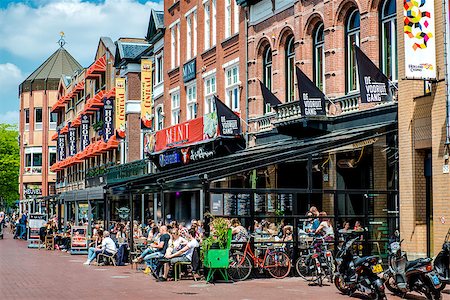 europe sidewalk cafe - Eindhoven, Netherlands - May 24, 2015: People sitting at outdoors restaurant in the main square of Eindhoven in sunny spring day. It is popular touristic place, with plenty of restaurants, bars, stores and clubs Photographie de stock - Aubaine LD & Abonnement, Code: 400-08332914