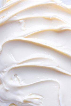 Wavy surface of light beige low-fat milky cream. Close-up photo. Photographie de stock - Aubaine LD & Abonnement, Code: 400-08333264