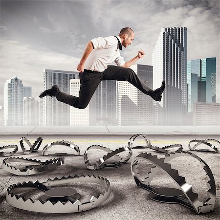 people running scared - Man runs quickly to overcome the traps Stock Photo - Budget Royalty-Free & Subscription, Code: 400-08344537