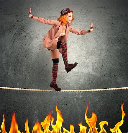 Clown balancing on a rope over fire Stock Photo - Budget Royalty-Free & Subscription, Code: 400-08342432