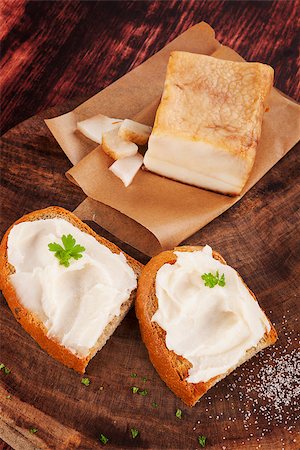 simsearch:400-04885499,k - Bread slice with lard on vintage wooden chopping board on wooden background. Traditional british eating. Stock Photo - Budget Royalty-Free & Subscription, Code: 400-08343438