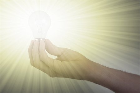 simsearch:400-04265413,k - Hand holding an light bulb isolated on white background Stock Photo - Budget Royalty-Free & Subscription, Code: 400-08377665