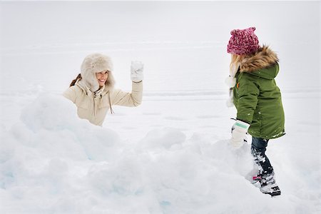 snow ball fights - Winter outdoors can be fairytale-maker for children or even adults. Portrait of happy mother and child playing snowball fight Stock Photo - Budget Royalty-Free & Subscription, Code: 400-08378152