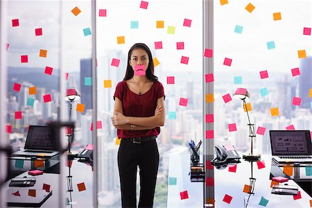 Mixed race woman working in modern office with reminders on skyscraper window. The girl feels stressed, holds a sticking note with sad emoticon on mouth. Stock Photo - Budget Royalty-Free & Subscription, Code: 400-08378399