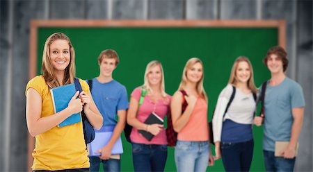 pupil in a empty classroom - A group of college students standing as one girl stands in front of them against blackboard with copy space on wooden board Stock Photo - Budget Royalty-Free & Subscription, Code: 400-08379783